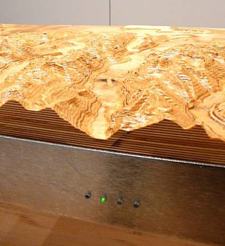 Illustration for article titled Topographic Tables Mix Geology With Interior Design